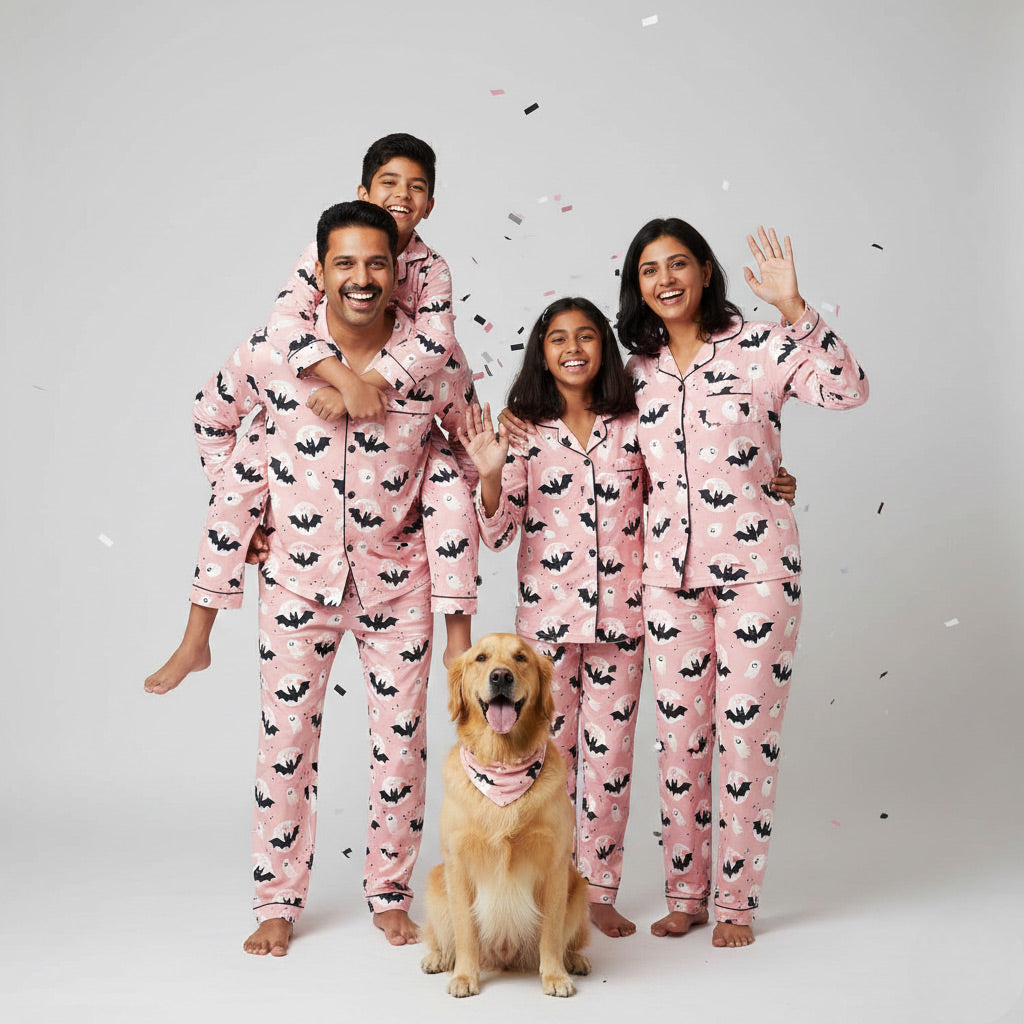 Family wearing Halloween themed matching pajamas, coordinated spooky print.