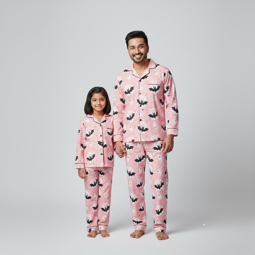 Father and daughter in Halloween matching pajama set, spooky themed coordinated nightwear.