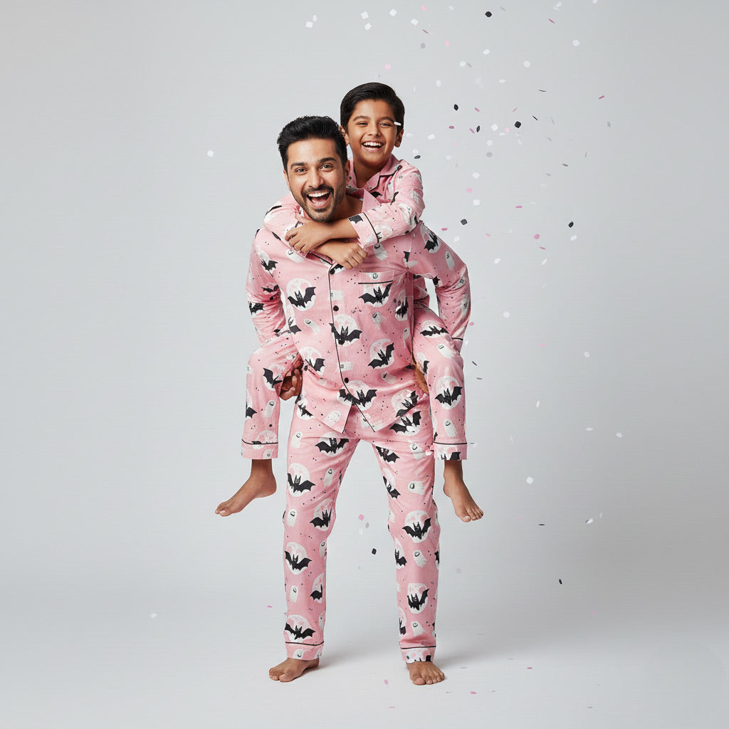 Father and son in Halloween print matching pajamas, spooky coordinated nightwear.