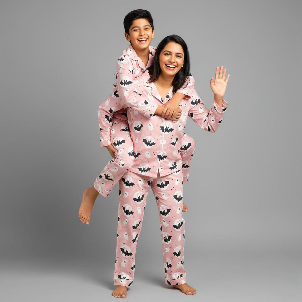 Mother and son in Halloween matching pajamas, spooky coordinated print.