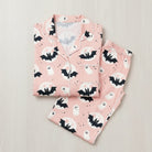 Pink pajama set with bat and ghost pattern on a light gray background