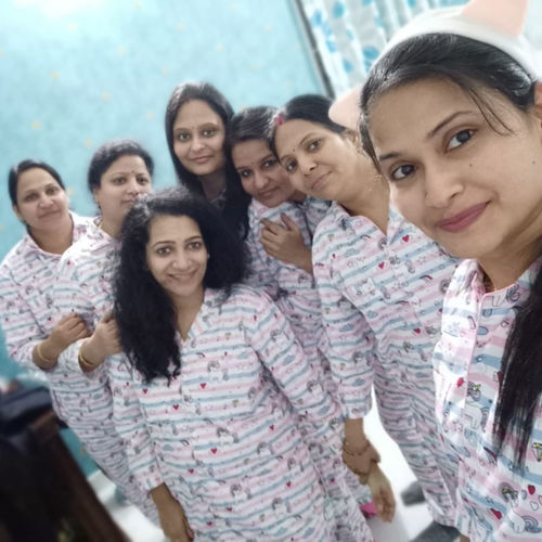 Group of women wearing matching pajamas posing for a photo.