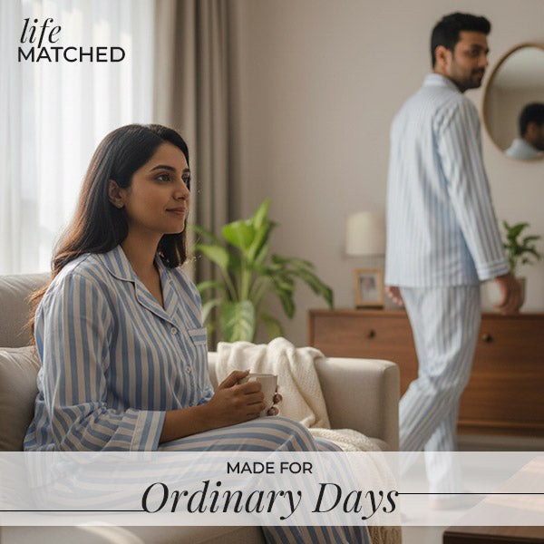 Couple relaxing at home in matching striped pajamas, capturing the comfort of everyday moments