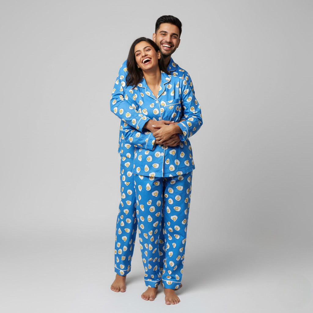Couple wearing omelette fry print matching pajamas, quirky breakfast-themed coordinated look.