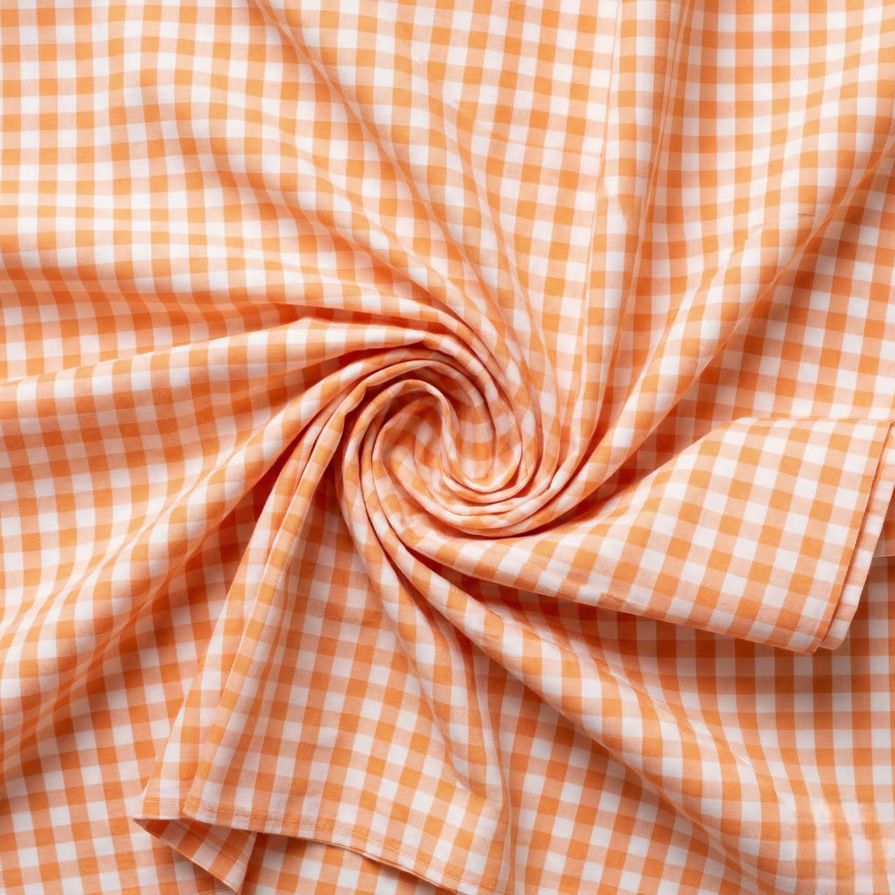 Close-up of orange and white checkered fabric in a swirl pattern