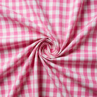 Pink and white checkered fabric in a swirl pattern