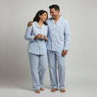 Matching couple cotton sleepwear in powder blue stripes.