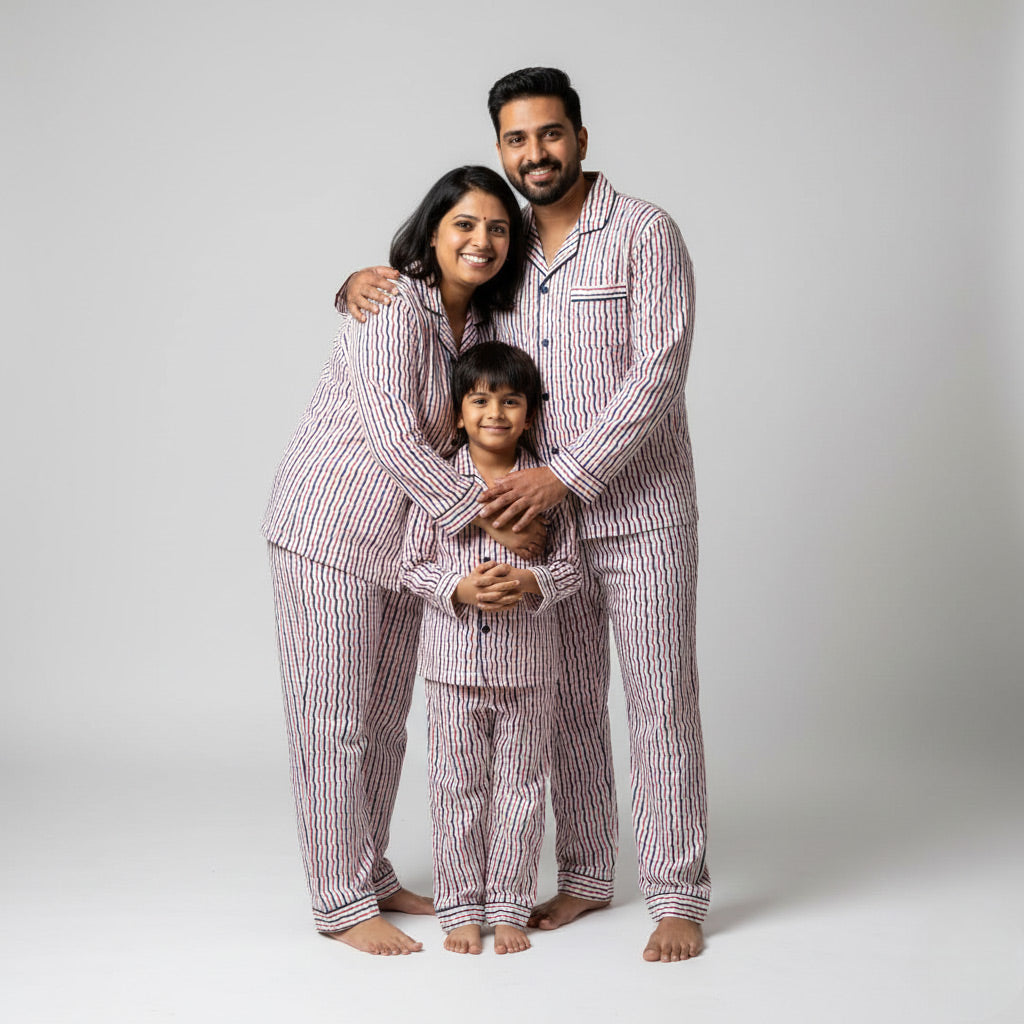Family wearing red and navy zigzag matching pajamas, vibrant coordinated outfits.