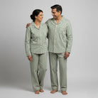 Couple cotton pajamas in sage green with cream stripes.