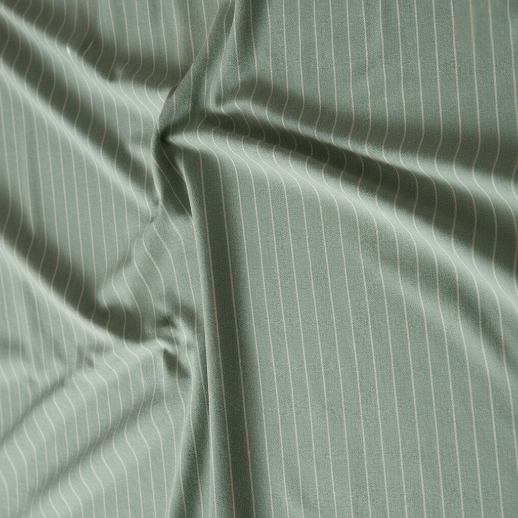 Sage green cotton fabric with soft ivory stripe design.