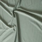 Sage green cotton fabric with soft ivory stripe design.