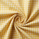 Yellow and white checkered fabric in a swirl pattern