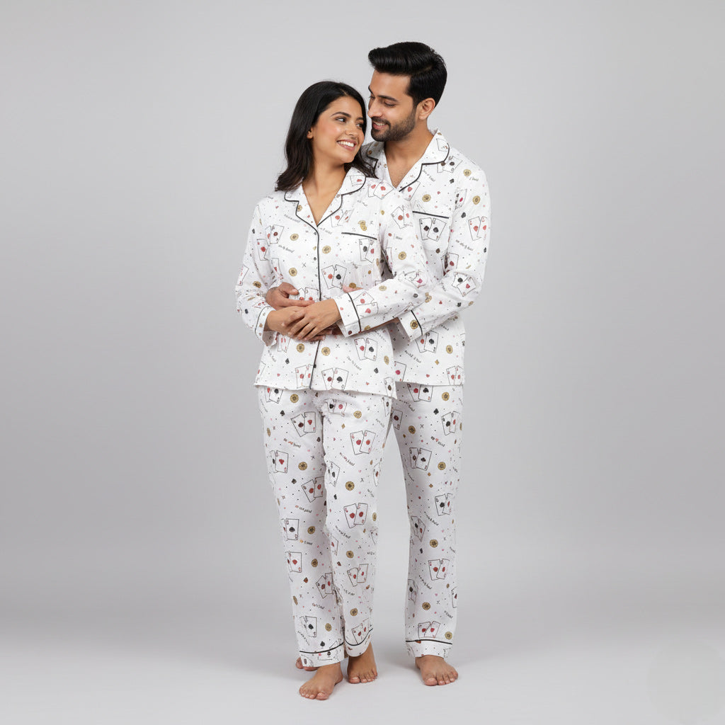Playing card print couple pajamas worn together as matching night suit