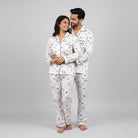 Playing card print couple pajamas worn together as matching night suit