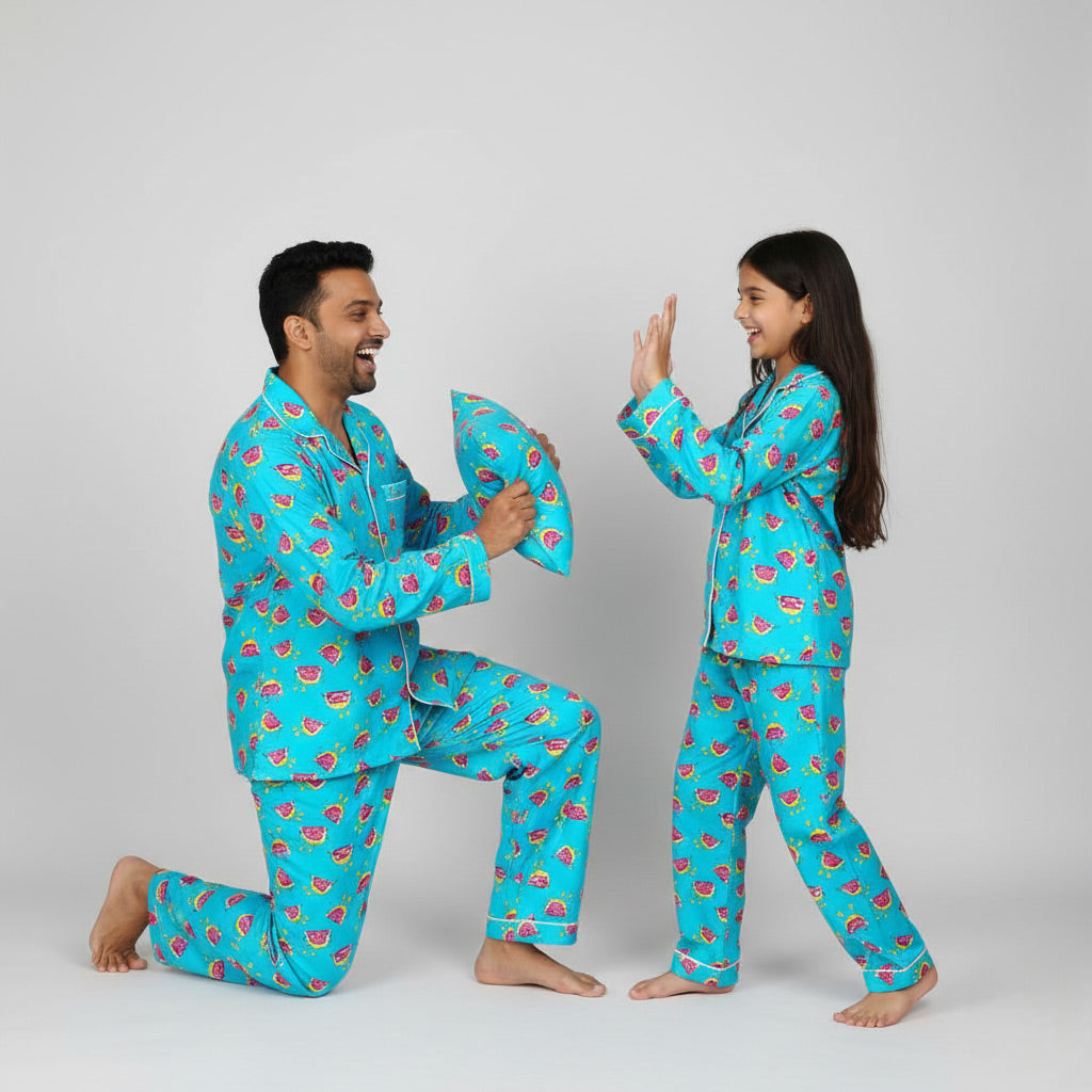 Father and daughter wearing watermelon print matching pajamas, bright fun coordinated set.