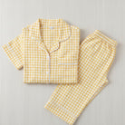 Yellow gingham pajama set on a light gray background